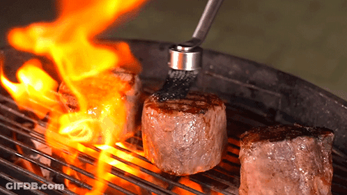 Three Steaks On Grill With Brush GIF