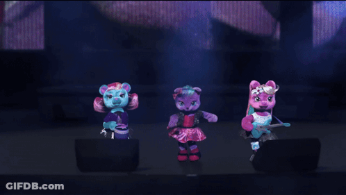 Three Stuffed Animals Are Dancing On A Stage And One Has A Microphone In Her Hand GIF
