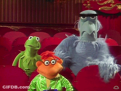 Three Stuffed Animals Are Sitting In A Theater Including Kermit The Frog And Sesame Street Characters GIF