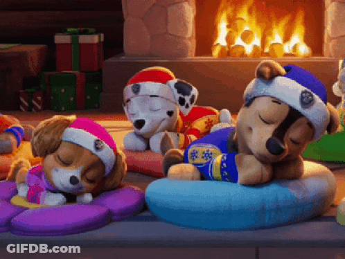 Three Stuffed Animals Sleeping By Fireplace GIF