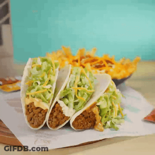 Three Tacos Next To French Fries GIF