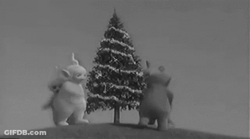 Three Teletubbies Next To Christmas Tree On Hill GIF