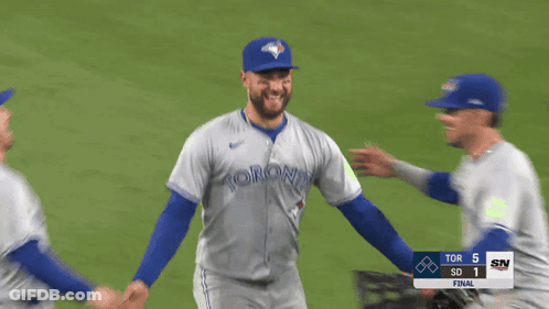 Three Toronto Blue Jays Players Hugging On Baseball Field GIF