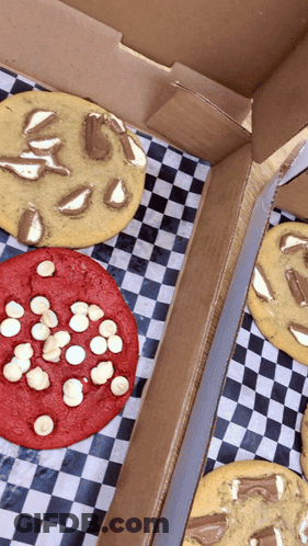 Three Types Of Cookies In A Box On Checkered Paper GIF