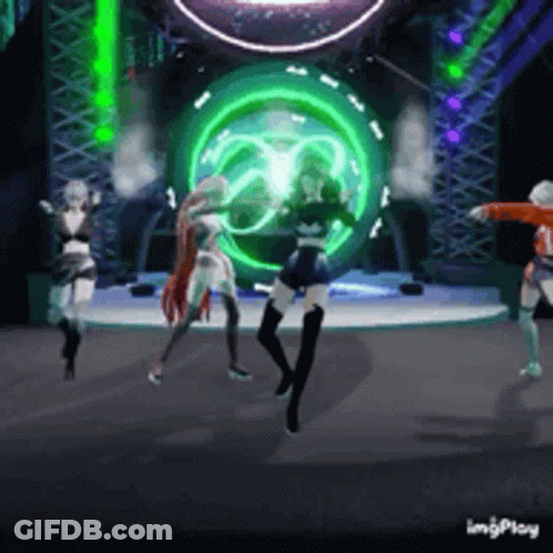 Three Women Are Dancing On A Stage In Front Of A Green Light GIF