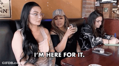 Three Women Are Sitting At A Table In A Restaurant . GIF