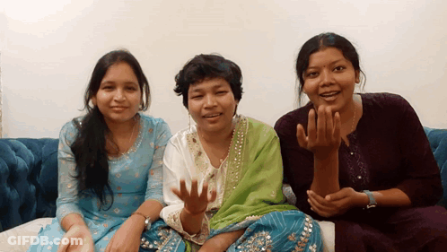 Three Women Are Sitting On A Couch And One Of Them Is Wearing A Wedding Ring GIF