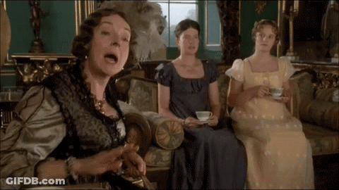 Three Women Are Sitting On A Couch One Is Holding A Cup And Saucer GIF