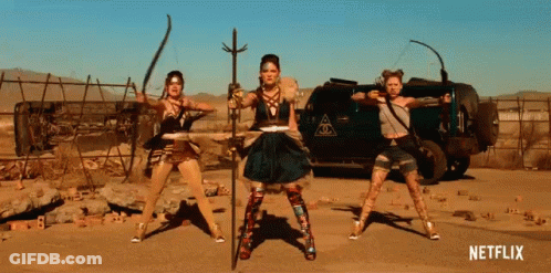 Women Standing In Front Of Netflix Sign GIF