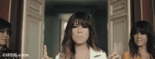 Three Women Are Standing Next To Each Other And One Is Pointing Up GIF