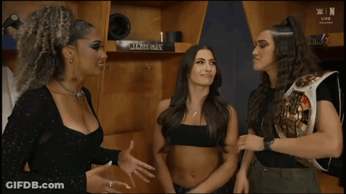 Three Women Are Standing Next To Each Other In A Room . GIF