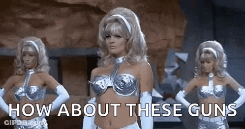 Three Women Are Standing Next To Each Other With Their Hands On Their Hips And The Words `` How About These Guns '' Abov GIF