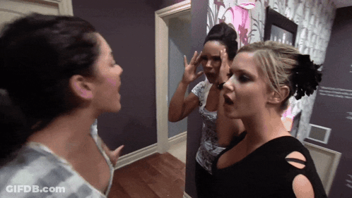 Three Women Beside Purple Wall GIF