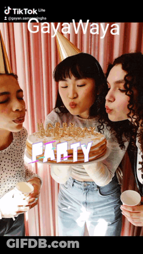 Three Women Blowing Out Candles On A Cake That Says Party On The Bottom GIF