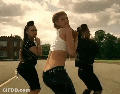 Three Women Dancing In Field With Castle GIF