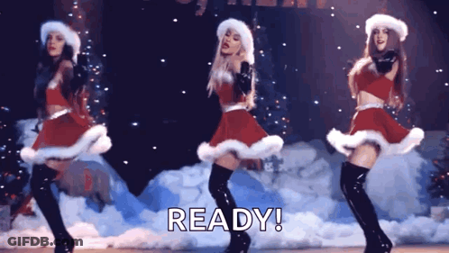 Three Women Dancing In Santa Costumes GIF