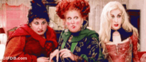 Three Women Dressed As Witches Standing In Living Room GIF