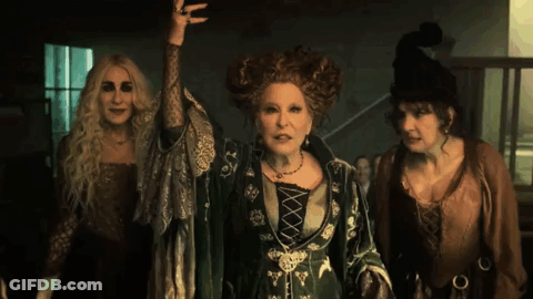 Three Women Dressed As Witches Standing Together GIF