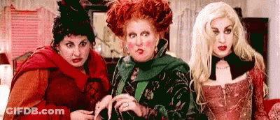 Three Women Dressed As Witches Standing Together GIF