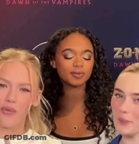 Three Women Eyes Closed In Front Of Dawn Of The Vampires Poster GIF