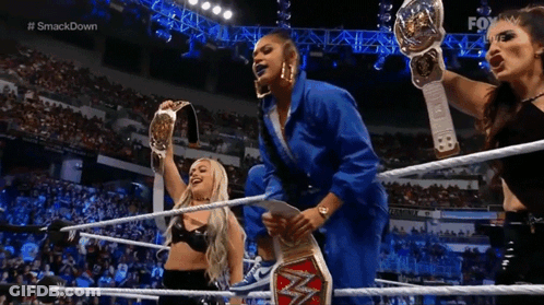 Three Women Holding Championship Belts In Wrestling Ring GIF