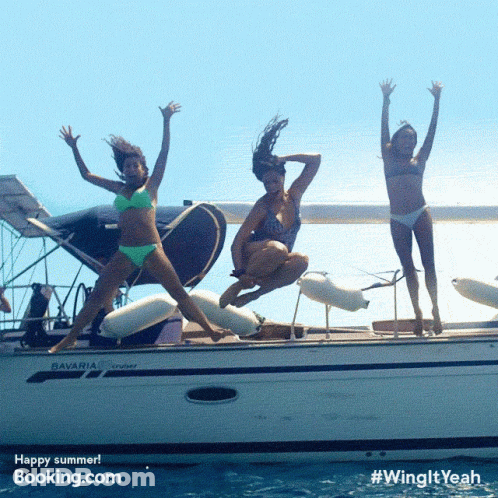 Three Women In Bikinis Jumping Off A Boat That Says Bavaria On It GIF