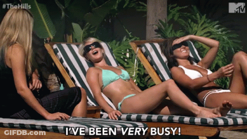 Three Women In Bikinis Lying On Lawn Chairs GIF