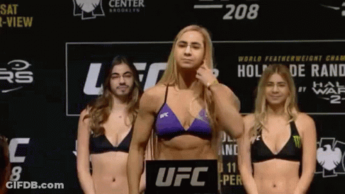 Three Women In Bikinis On Scale GIF