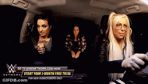 Three Women In Car With Sign Saying Go To WWENetwork.com GIF