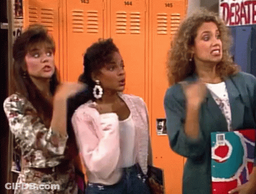 Three Women In Front Of Orange Lockers Saying Debate GIF