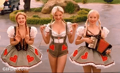 Three Women In German Costumes Standing Together GIF