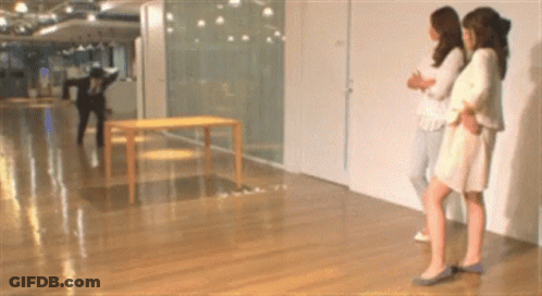 Three Women In Hallway With Man In Black Jacket GIF