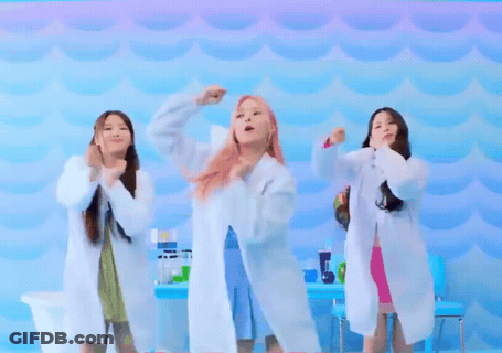 Three Women In Lab Coats Are Dancing In Front Of A Blue Background GIF