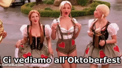 Three Women In Oktoberfest Costumes Standing Together GIF