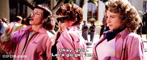 Three Women In Pink Jackets Are Standing Next To Each Other And One Of Them Is Saying Okay Girls Let 'S Go Get Em GIF