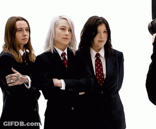 Three Women In Suits With Arms Crossed GIF