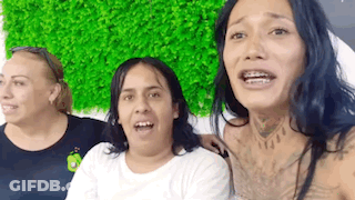 Three Women Sitting In Front Of Green Wall GIF