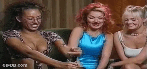Three Women Sitting On Couch Holding Wine Glasses GIF