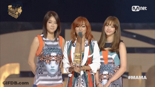 Three Women Stand On A Stage At A Mnet Event GIF