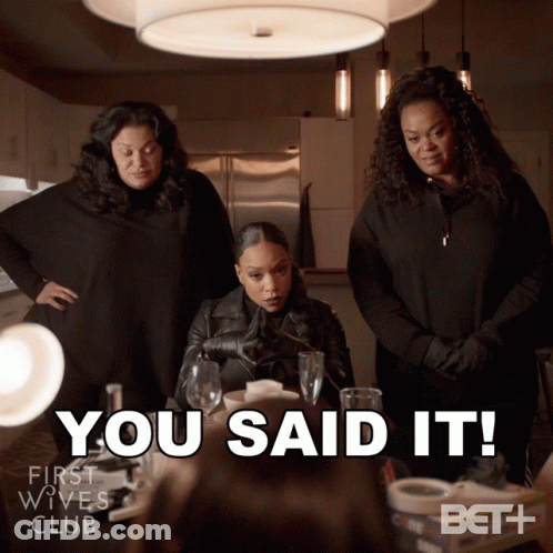Three Women Standing Around A Table With The Words You Said It GIF