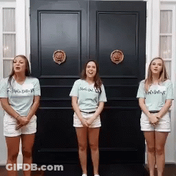 Three Women Standing In Front Of A Black Door With One Wearing A Shirt That Says I 'M A Delta GIF