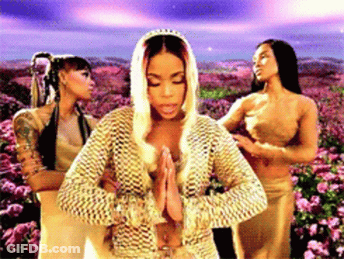 Three Women Standing In Front Of A Field Of Flowers GIF