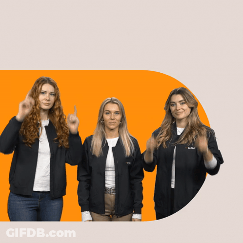 Three Women Standing Next To Each Other With One Wearing T-Mobile Jacket GIF