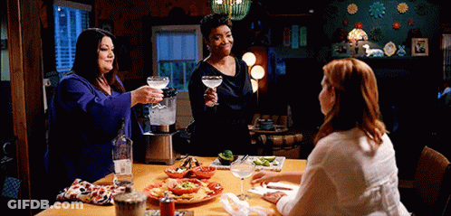 Three Women Toasting With Drinks And Food GIF