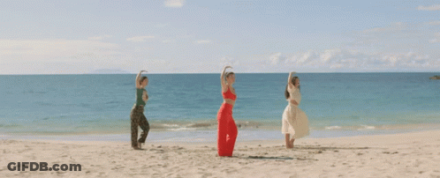 Three Women With Arms Outstretched On Beach GIF