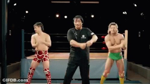 Three Wrestlers Dancing In Wrestling Ring Referee Watching GIF