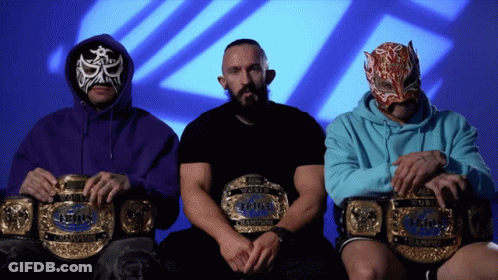 Three Wrestlers Holding World Heavyweight Champions Belts GIF