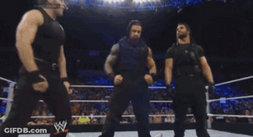 Three Wrestlers In A Wrestling Ring With A W Logo GIF
