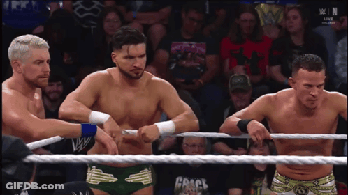 Three Wrestlers In Ring With Crack Rope GIF