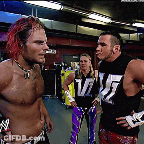Three Wrestlers Standing Together One Wearing WWE Shirt GIF